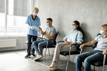 Middle eastern man patient filling papers before vaccinationの写真素材