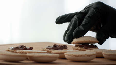 Pastry Chef Baking Macarons Cookies In Kitchen Indoors, Closeupの写真素材