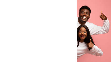 Happy african american lovers with horizontal advertising board