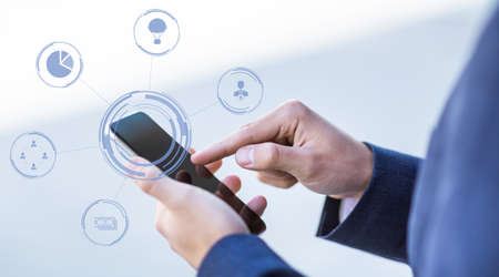 Cropped caucasian guy in suit typing on smartphone in city, collage with virtual hologram, abstract...
