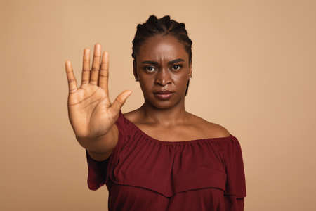 Young angry woman making the hand stop signの写真素材