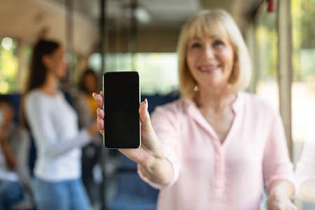 Woman showing black empty smartphone screen, closeupの写真素材