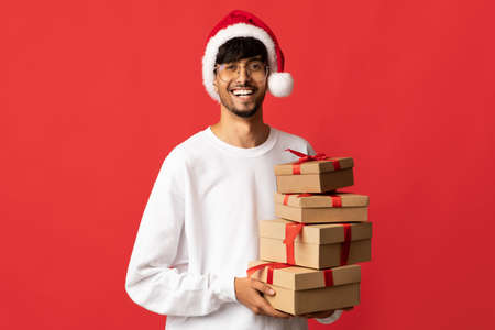 Happy arabic Santa holding New Year or Christmas presentsの写真素材