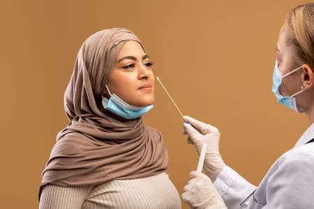 COVID-19 pcr test concept. Medical worker taking nasal swab for coronavirus sample test from...