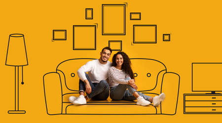 Cheerful arab couple planning and imagining new home interiorの写真素材