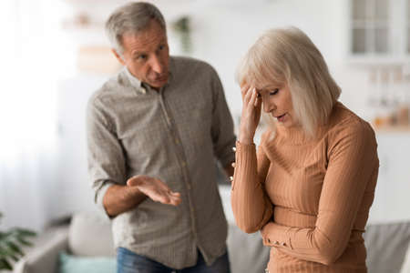 Angry Mature Husband Shouting At Unhappy Wife Having Conflict Indoor