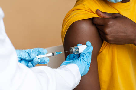 Doctor In Blue Gloves Taking Dose Of Vaccine From Vial With Syringeの写真素材