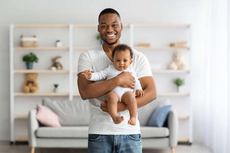 Portrait Of Happy Young African American Daddy Holding Adorable Infant Baby Son