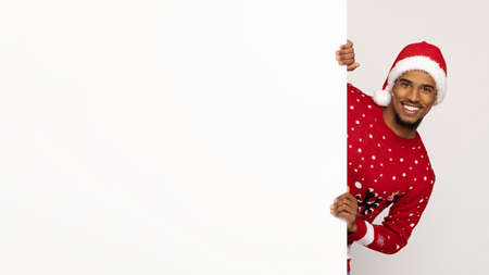 Funny black man standing by empty placard, panoramaの写真素材