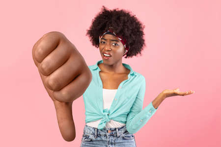 Irritated Black Young Woman Shrugging Shoulders Standing Over Pink Backgroundの写真素材