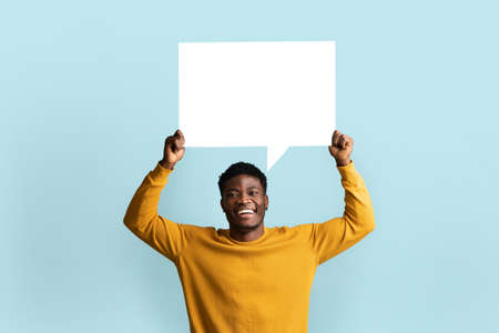Cheerful black man holding empty communication chartの写真素材