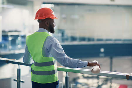 Young back man architect checking construction site