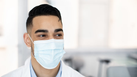 Closeup Shot Of Middle Eastern Male Medical Worker In Oritective Face Maskの写真素材