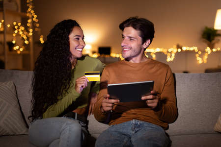 Spouses Using Tablet And Credit Card Shopping Online At Homeの写真素材