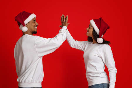 african american man and woman giving each other high five