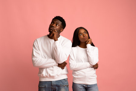 Confused african american man and woman looking asideの写真素材