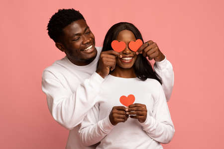 Handsome black guy making surprise for girlfriend on Valentine