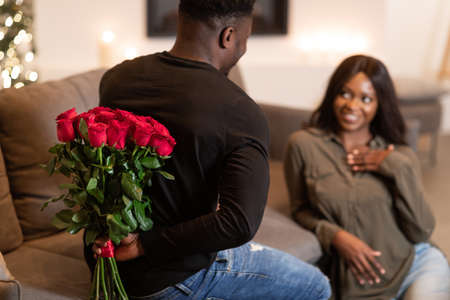 African Husband Giving Flowers To Wife On Valentines Day Indoorの写真素材