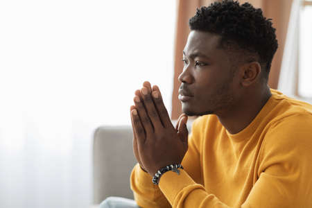 Thoughtful african american guy having headache, closeup portraitの写真素材