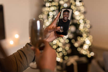 Female Video Calling Via Phone Boyfriend Celebrating Xmas Indoor, Croppedの写真素材