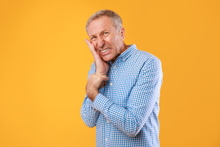 Portrait of unhappy mature man suffering from toothacheの写真素材