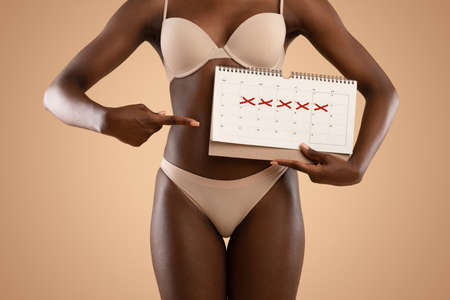 Unrecognizable african american woman pointing at calendarの写真素材