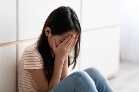Closeup of crying long-haired brunette school-aged girlの写真素材