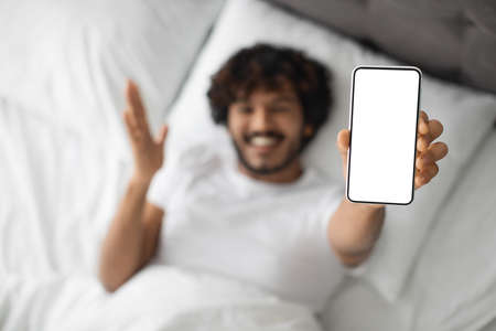 Modern smartphone with blank screen in indian guy hand