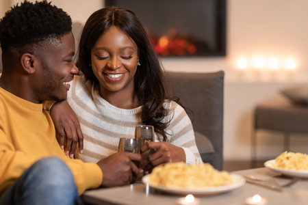 African American Spouses Clinking Glasses Toasting During Romantic Dinner Indorの写真素材