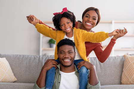 Family Leisure. Happy Black Mom, Dad And Daughter Having Fun At Homeの写真素材