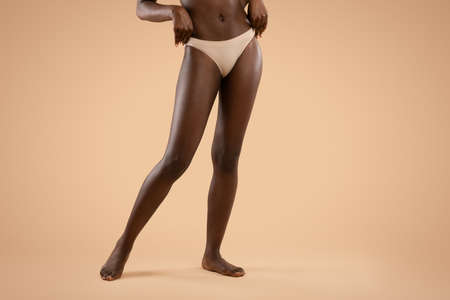 Long slim legs of unrecognizable african american woman