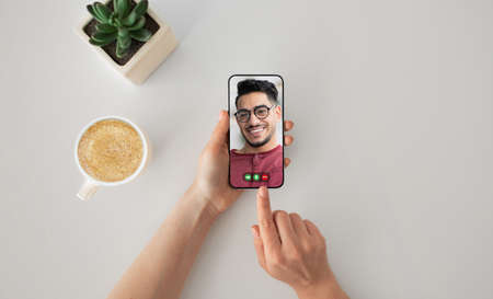 Unrecognizable woman having video chat with middle-eastern man