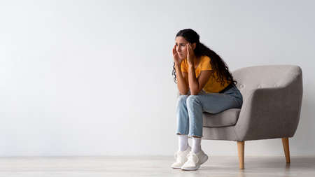 Depression Concept. Upset Worry Young Woman Sitting In Armchair At Homeの写真素材