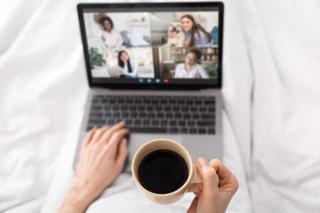 Virtual Meeting. Unrecognizable Lady Drinking Coffee And Making Video Call With Friendsの写真素材