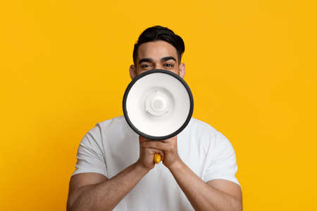 Arabic guy covering his mouth with megaphoneの写真素材