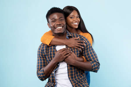 African American woman cuddling with her man