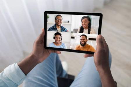 Unrecognizable disabled man having call with cheerful friends, using padの写真素材