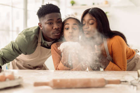 Black Family Blowing Flour To Camera While Baking In Kitchen