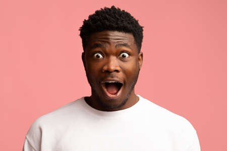 Amazed black guy looking at camera, closeup shotの写真素材