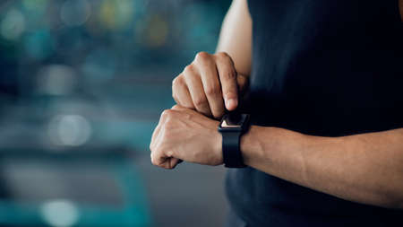 Sport Gadgets Concept. Unrecognizable Male Athlete Checking His Fitness Activity On Smartwatch