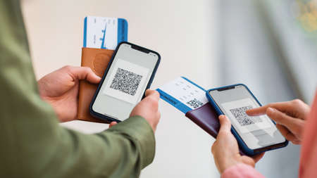 Tourists Holding Smartphones With Covid Certificate QR Code Indoor, Croppedの写真素材