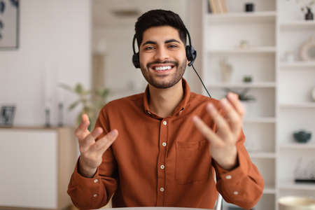 Arab man having video call and talking at webcam