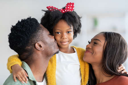 Portrait Of Happy Black Family, Young Parents And Cute Little Daughterの写真素材