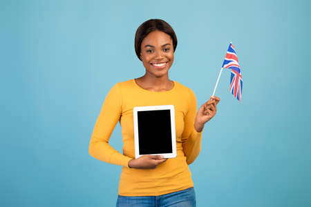 Study English Online. Black Female Holding British Flag And Blank Digital Tabletの写真素材