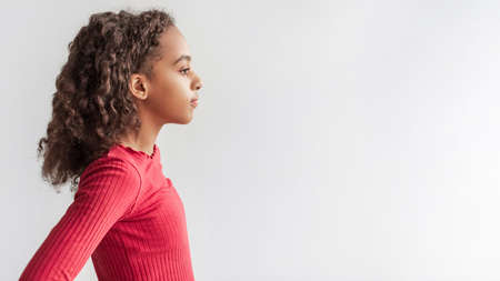 Profile Portrait Of Serious African American Girl Over Gray Backgroundの写真素材
