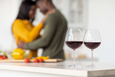 Selective Focus On Two Wine Glasses With Romantic Black Couple On Backgroundの写真素材