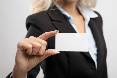 Business card mockup. Businesswoman holding blank card for clients or business partners, selective focus on empty cardの写真素材