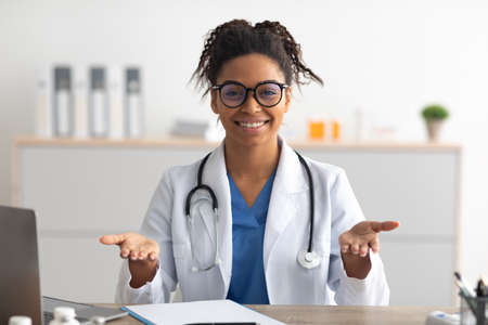 Portrait of black female medical practitioner talking to camera