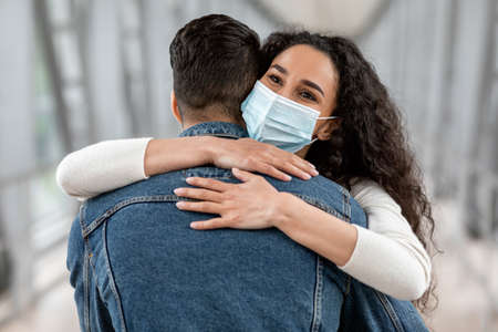 Happy Reunion. Man And Woman In Medical Mask Embracing At Airport, Closeupの写真素材