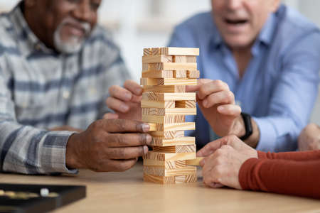 Cropped of multiracial senior people playing blocks at homeの写真素材